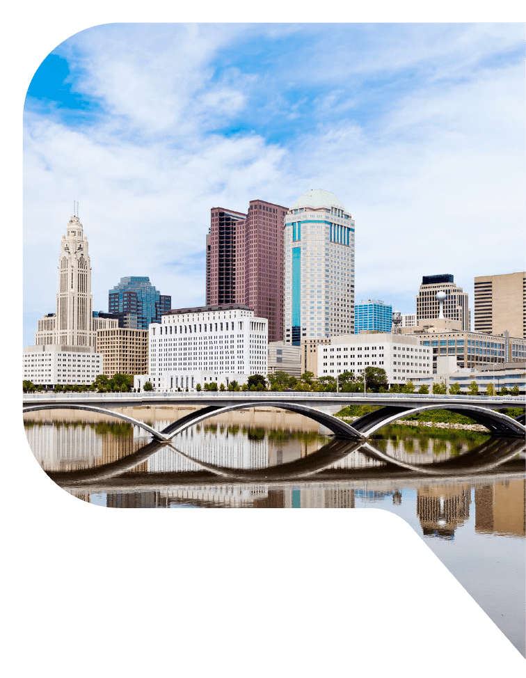 Columbus, Ohio skyline, views from across the river with a low bridge supported by arches in the foreground.